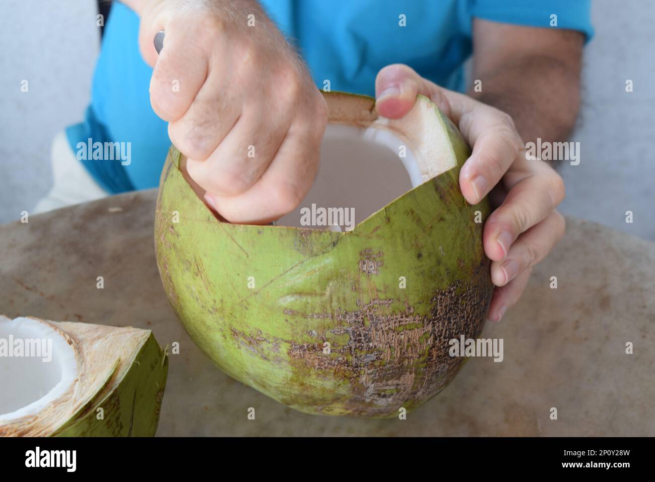 Person is eating coconut pulp in a beach cafe Stock Photo Alamy
