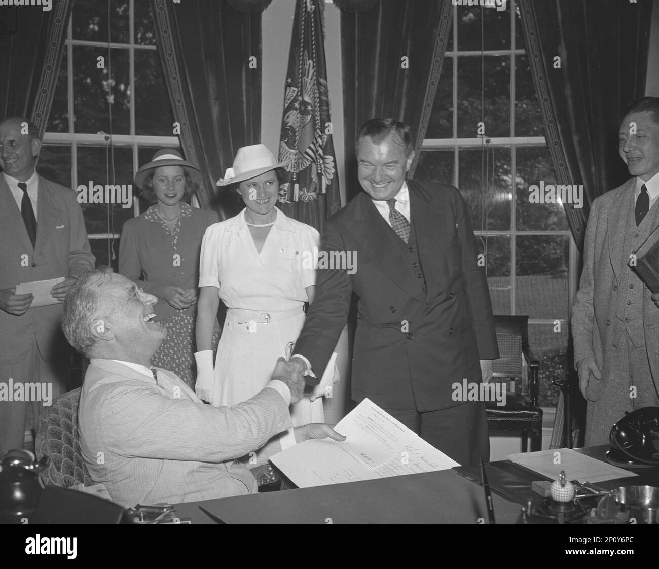 Robert H. Jackson Sworn in As Justice, Washington, D.C. July 11 1941. Robert [Houghwout] Jackson Was Sworn in As Associate Justice of The Supreme Court in President Roosevelt's Office Before An Audience Comprising Most of The High Officials of The New Deal with Whom He Had Been Associated For Seven Years. Picture Shows The President As He Congratulates Jackson. Left To Right: Mary Jackson, Daughter of Mr. Jackson, Mrs. Jackson [Irene Gerhardt] And Robert Jackson. President Roosevelt Is in Left Foreground. Stock Photo