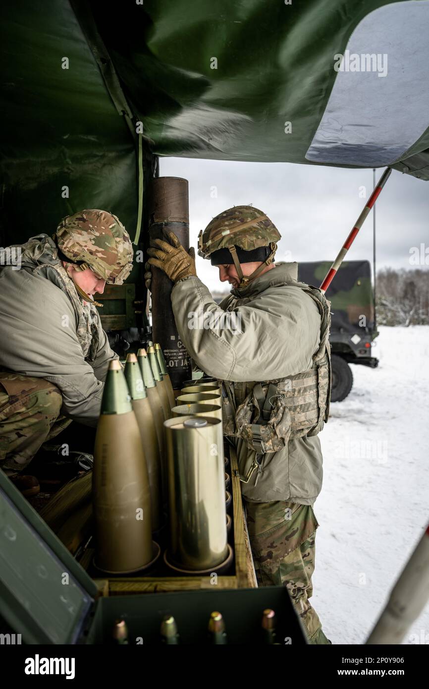 Army Cpl. Brady Kielpikowski and Pfc. Dominic Tilton, 1-120th Field Artillery Regiment, assemble a 105mm High Explosive shell to be used with the M119 howitzer during Northern Strike 23-1, Jan. 23, 2023, at Camp Grayling, Mich. Units that participate in Northern Strike’s winter iteration build readiness by conducting joint, cold-weather training designed to meet objectives of the Department of Defense’s Arctic Strategy. Stock Photo