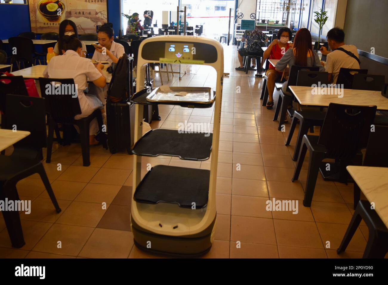 Robot waiter is serving food in a cafe in Malaysia. Stock Photo