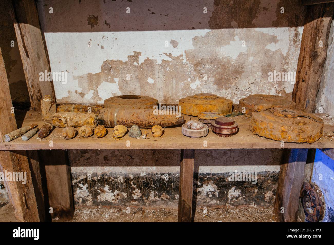 Old rusty ammo, tank shells, mines and grenades, dug out after demining ...
