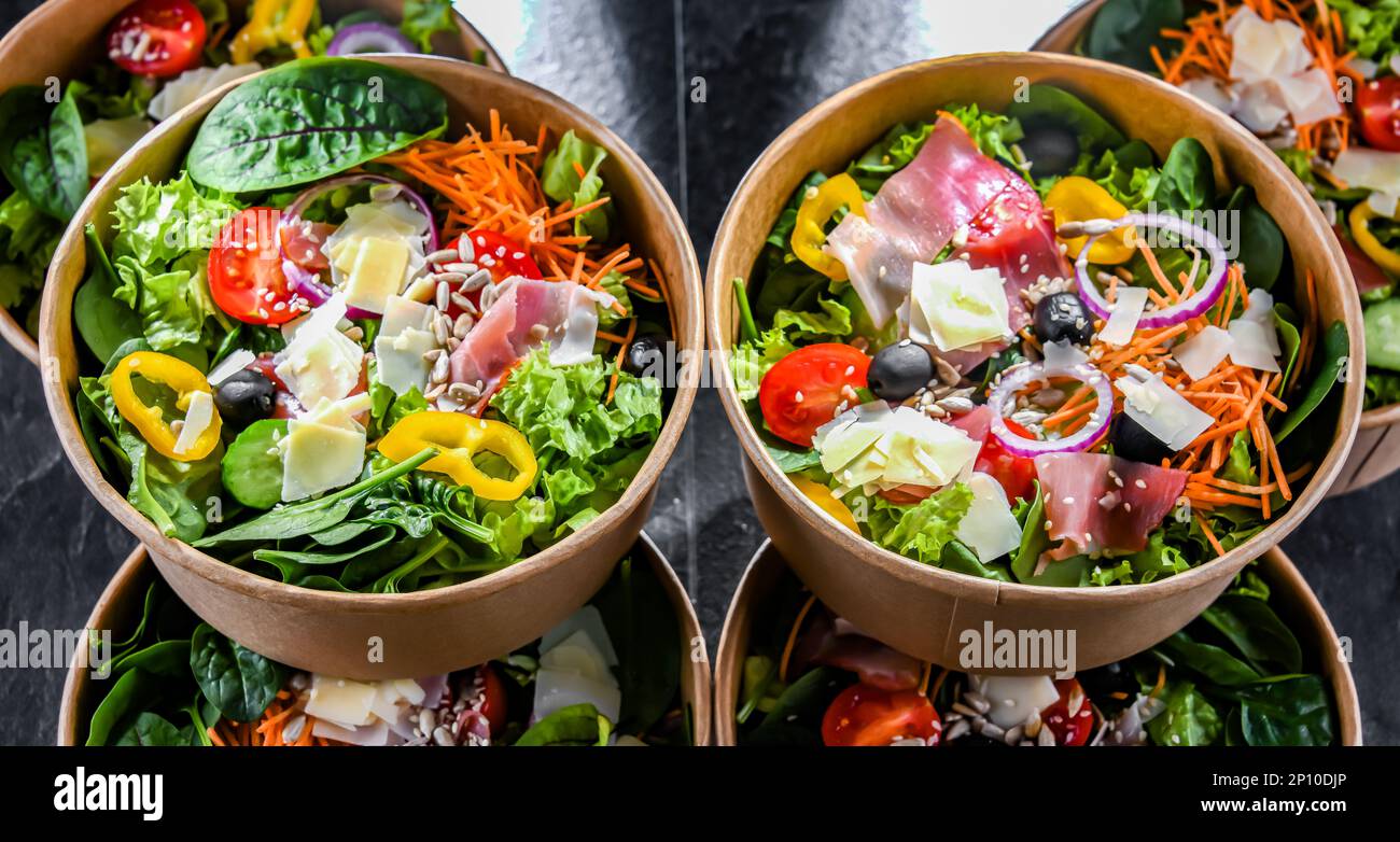Round paper boxes with prepackaged vegetable salads ready for sale
