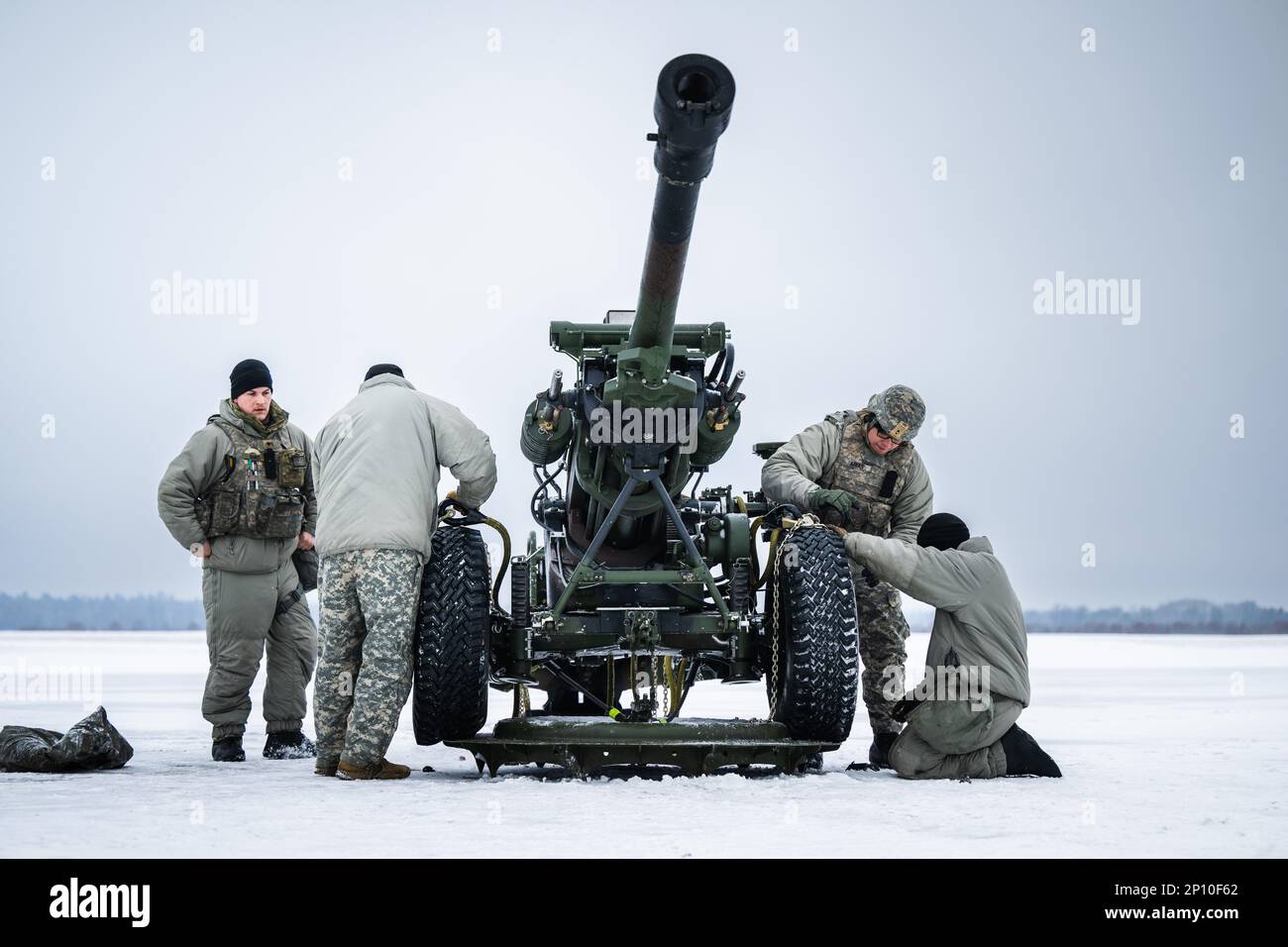 Soldiers from the 1-120th Field Artillery Regiment, Wisconsin National Guard, secure and prepare the M119 howitzer for sling load operations with a UH-60 Blackhawk from the 1-147th Aviation Regiment, Michigan National Guard, during Northern Strike 23-1, Jan. 24, 2023, at Grayling Army Airfield, Mich. Units that participate in Northern Strike’s winter iteration build readiness by conducting joint, cold-weather training designed to meet objectives of the Department of Defense’s Arctic Strategy. Stock Photo