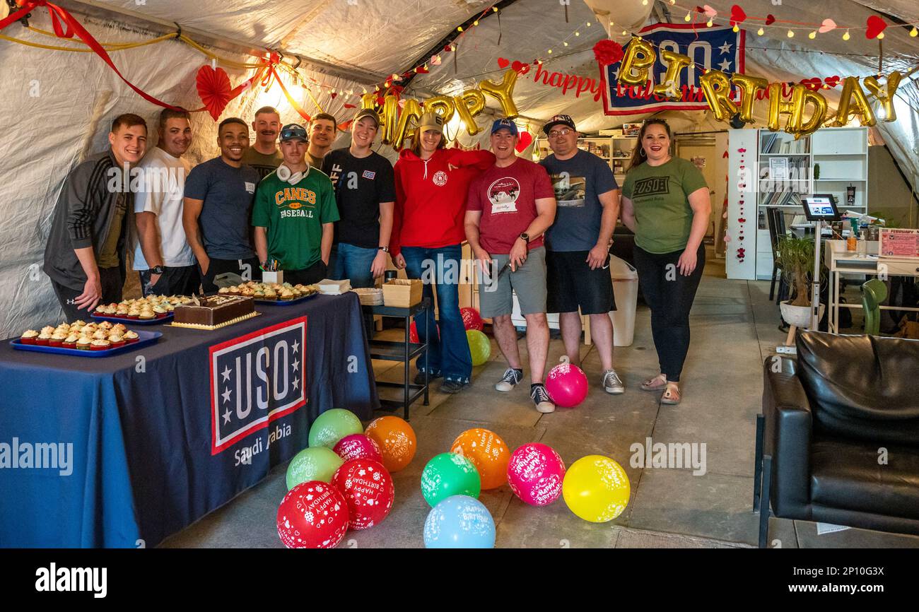 Members of Team PSAB take a photo during USO Saudi Arabia's 82nd birthday party at Prince Sultan Air Base, Saudia Arabia, Feb. 4, 2023. The celebration included cake, balloons, raffle prizes and camaraderie. The USO has been serving U.S. military service members by keeping them connected to family, home and country since 1941. Stock Photo