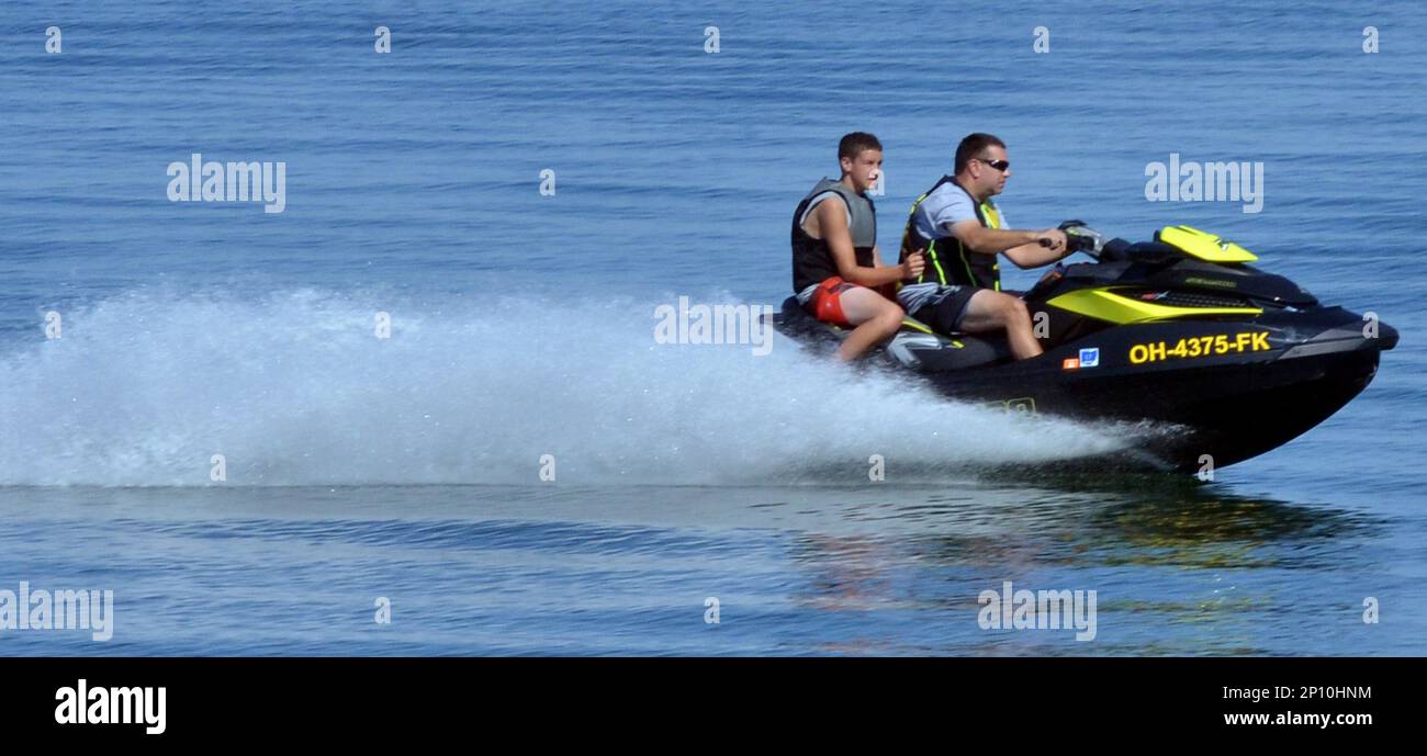 Jet ski riders ride on Lake Erie along Breakwater Beach at Geneva State