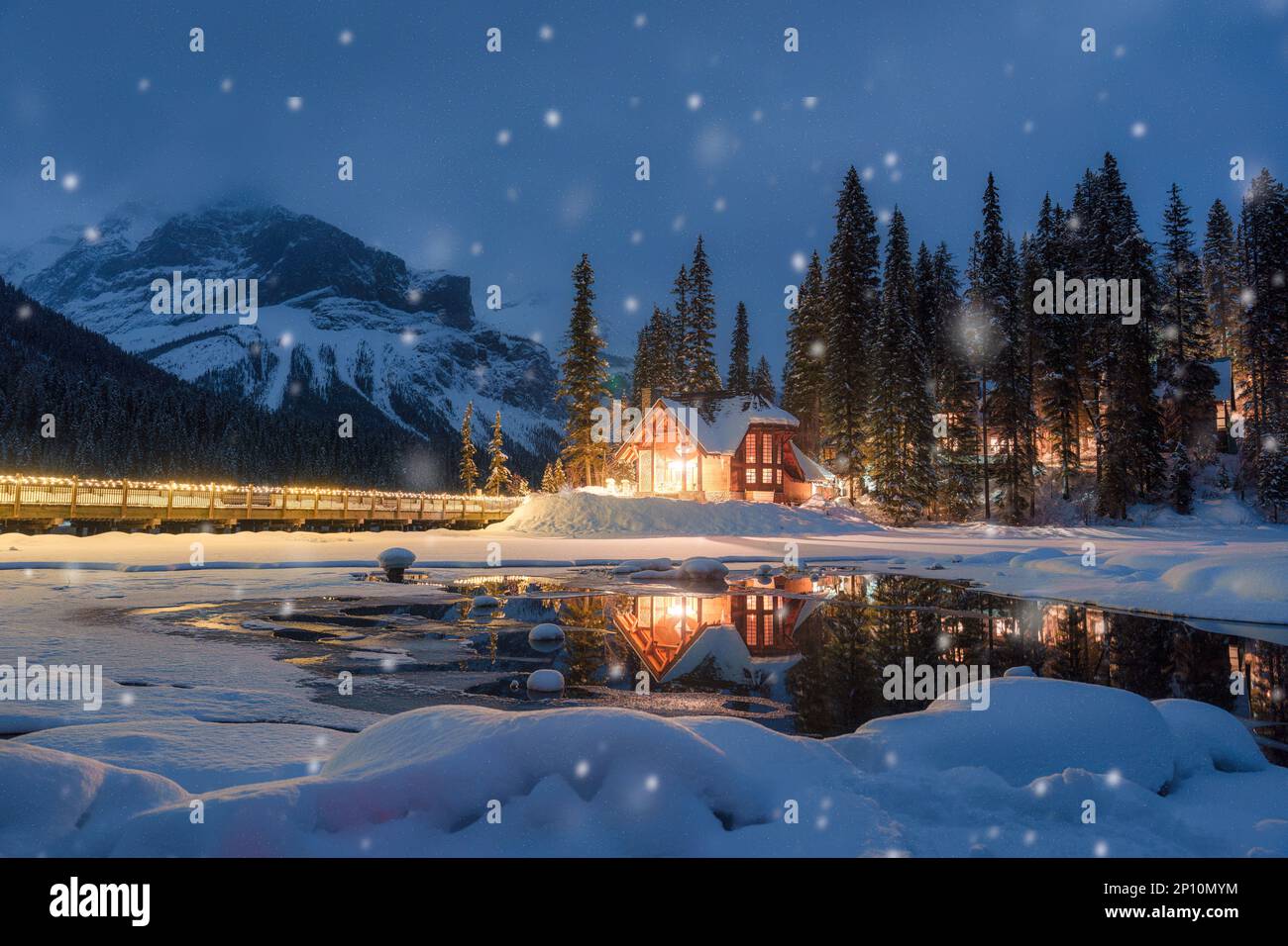 Beautiful view of Emerald Lake with wooden lodge glowing and snowfall ...