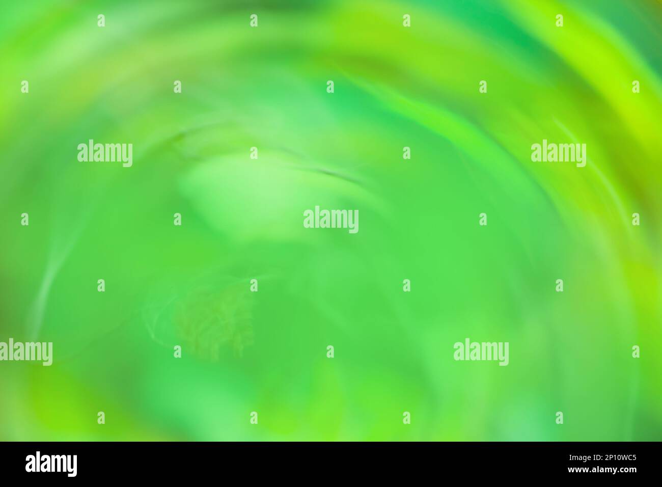 Green abstract multi colored light trail vortex. Fresh green lights moving in circular pattern. Stock Photo