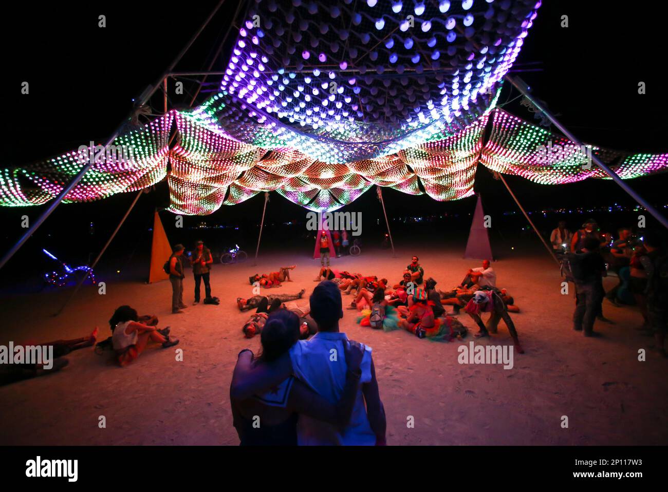 Brandi DeCarli, left, and Tim Wegman take in an art installation during Burning Man at the Black