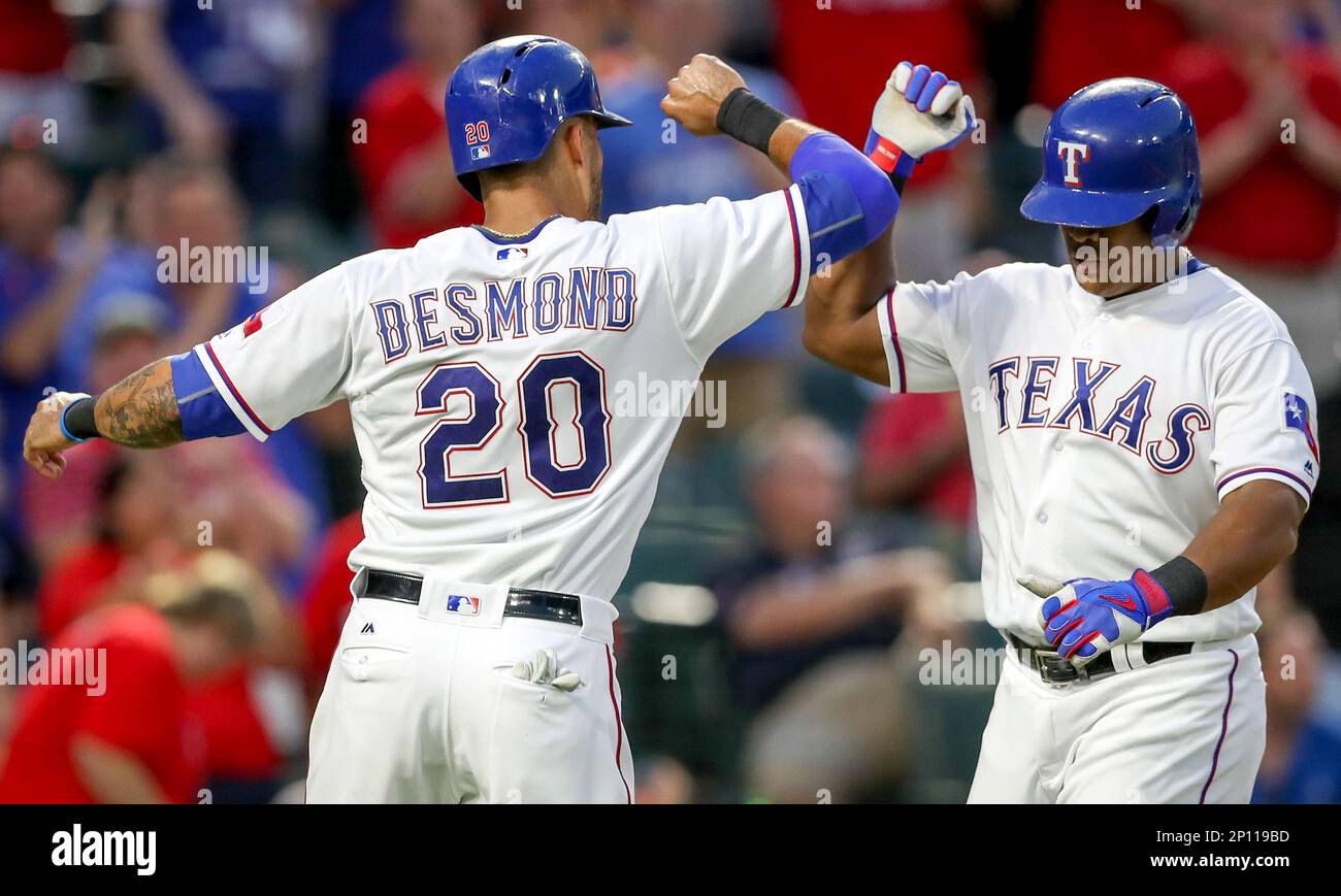 Adrian Beltre #29 of the Texas Rangers is congratulated by Ian Desmond #20  after the two scored on B…