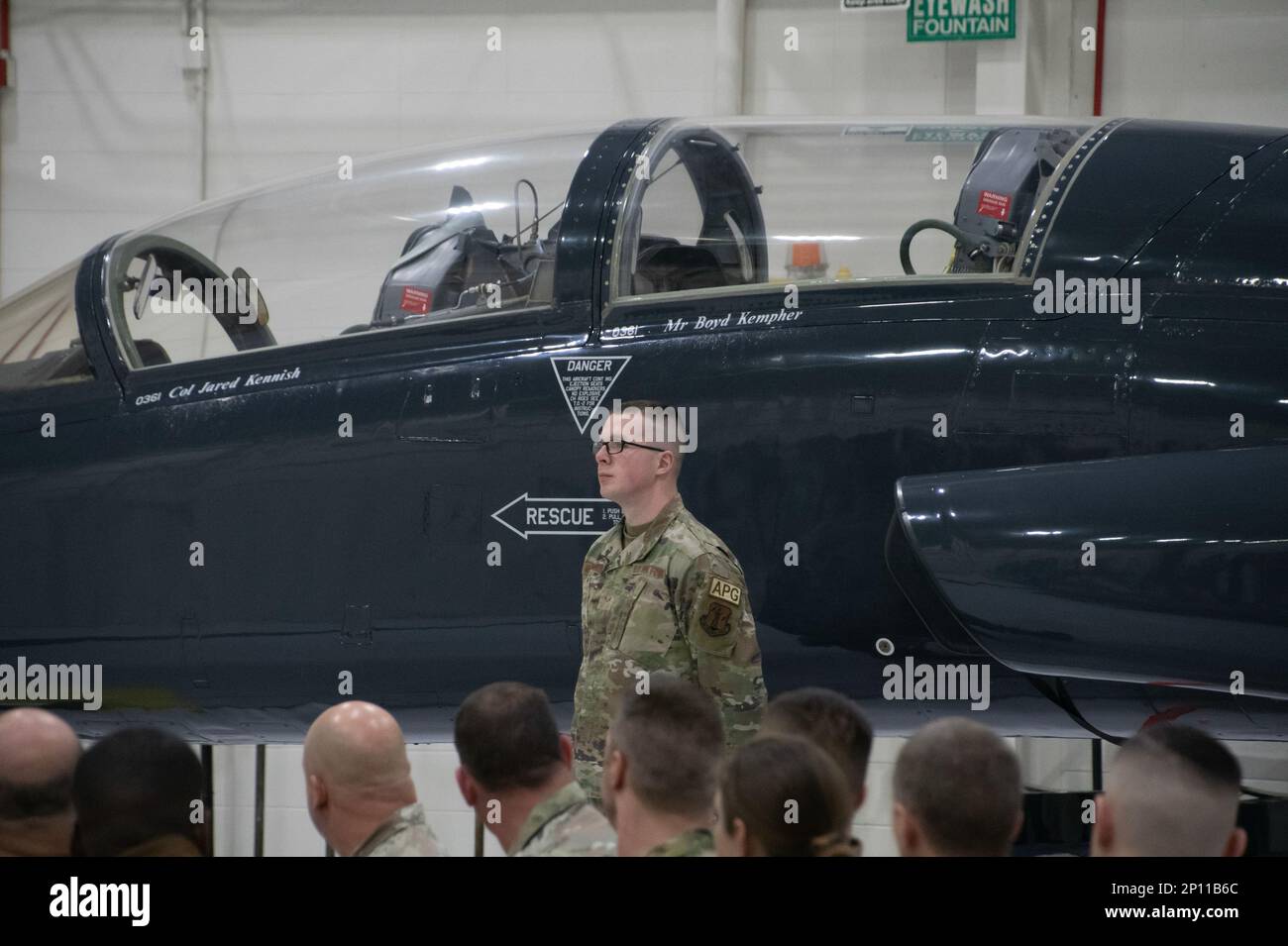 Senior Airman Justin Meinershagen, 131st Bomb Wing maintainer, stands at parade rest after revealing the newly-added name of Col. Jared Kennish to a T-38 Talon trainer jet during a change of command ceremony at Whiteman Air Force Base, Missouri, Feb. 3, 2023. During the ceremony Col. Jared P. Kennish assumed command of the 131st Bomb Wing from Col. Matthew D. Calhoun. Stock Photo