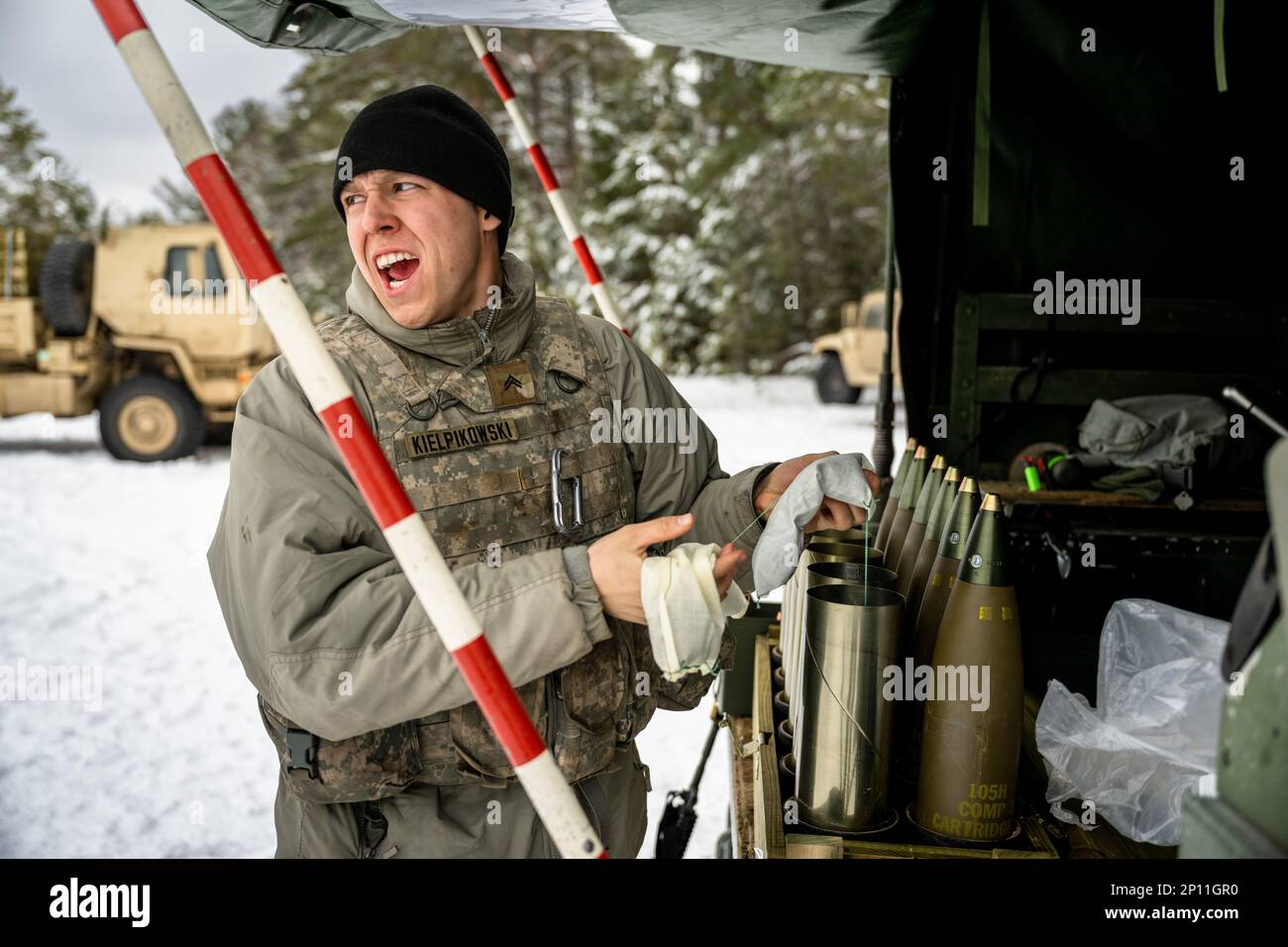 Army Cpl. Brady Kielpikowski, 1-120th Field Artillery Regiment, assembles a 105mm High Explosive shell to be used with the M119 howitzer during Northern Strike 23-1, Jan. 23, 2023, at Camp Grayling, Mich. Units that participate in Northern Strike’s winter iteration build readiness by conducting joint, cold-weather training designed to meet objectives of the Department of Defense’s Arctic Strategy. Stock Photo