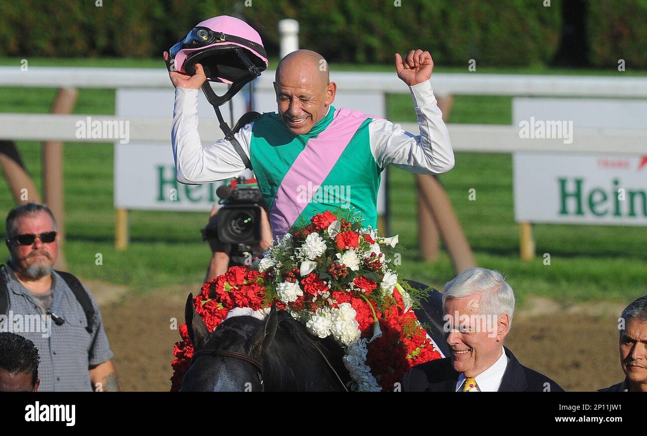 Jockey Mike Smith aboard Arrogate, celebrates after winning the Travers