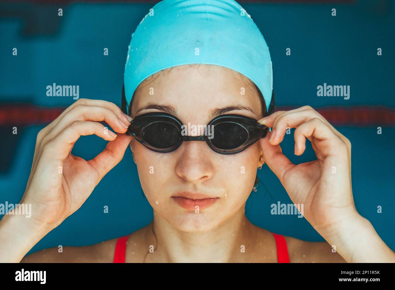 Extreme closeup shot of a Caucasian girl head with a swimming cap and