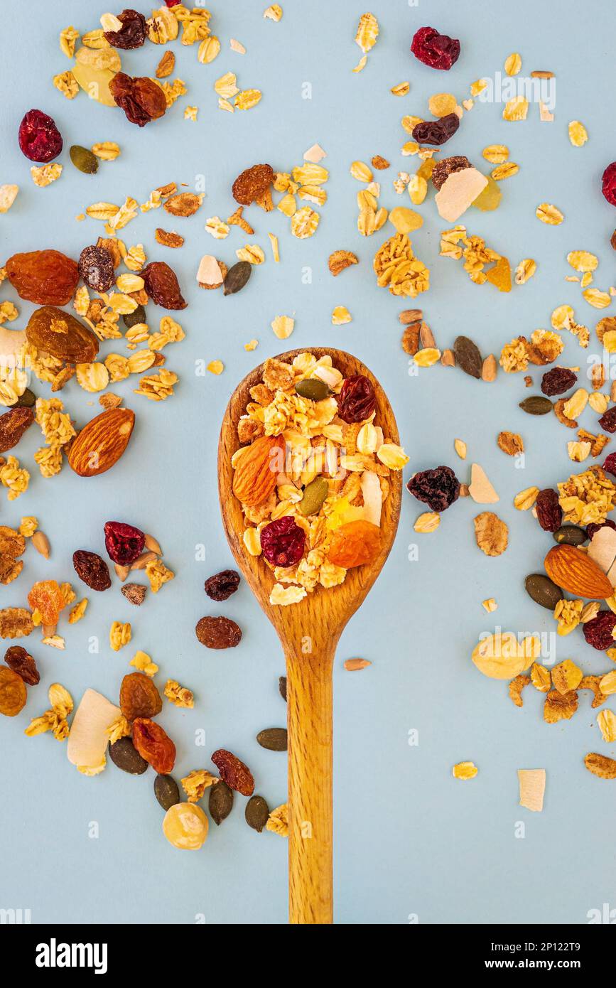 Wooden spoon with muesli on blue background Stock Photo