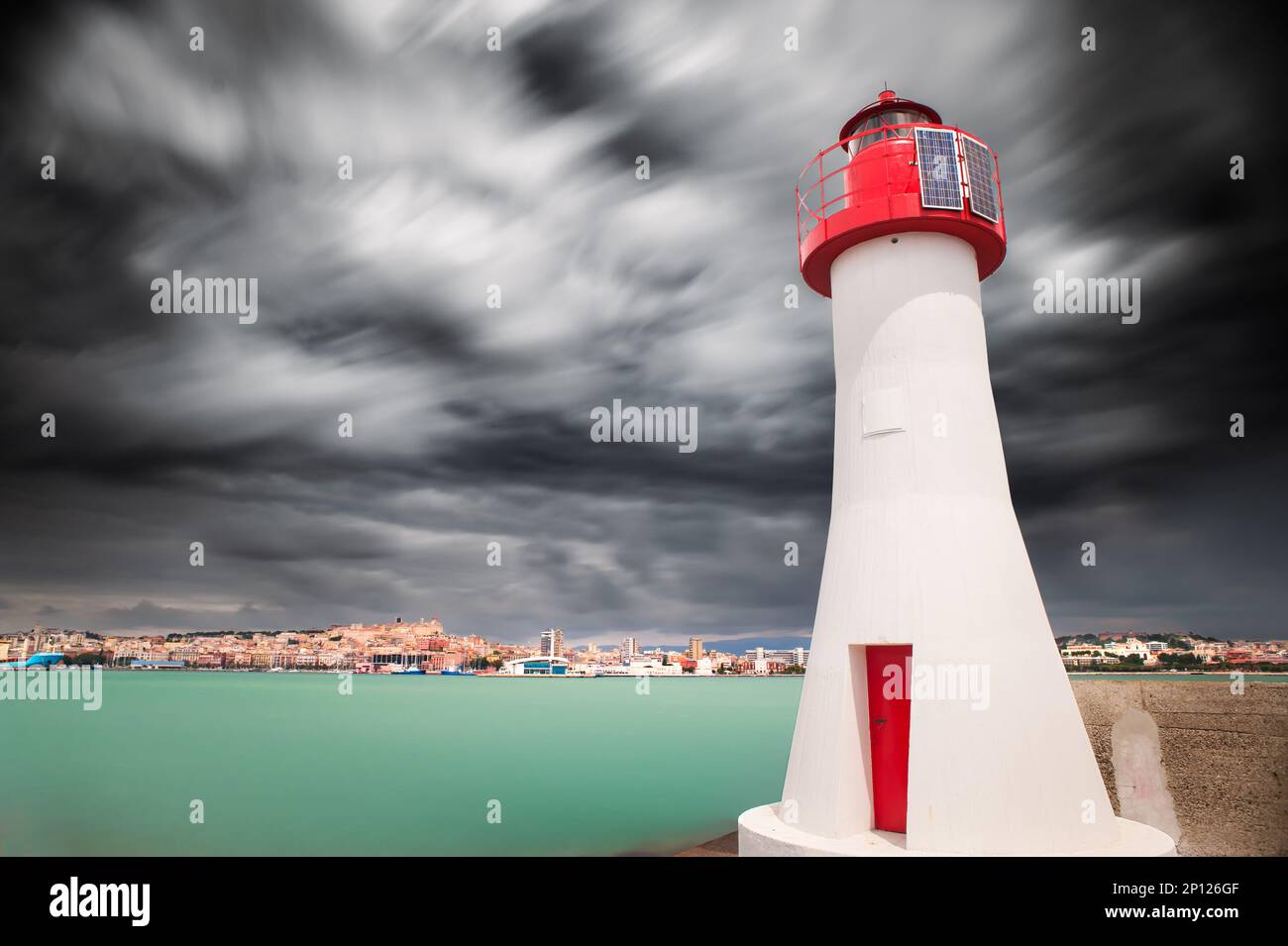 Red light at the entrance to the Cagliari Harbor in  long exposure. Stock Photo