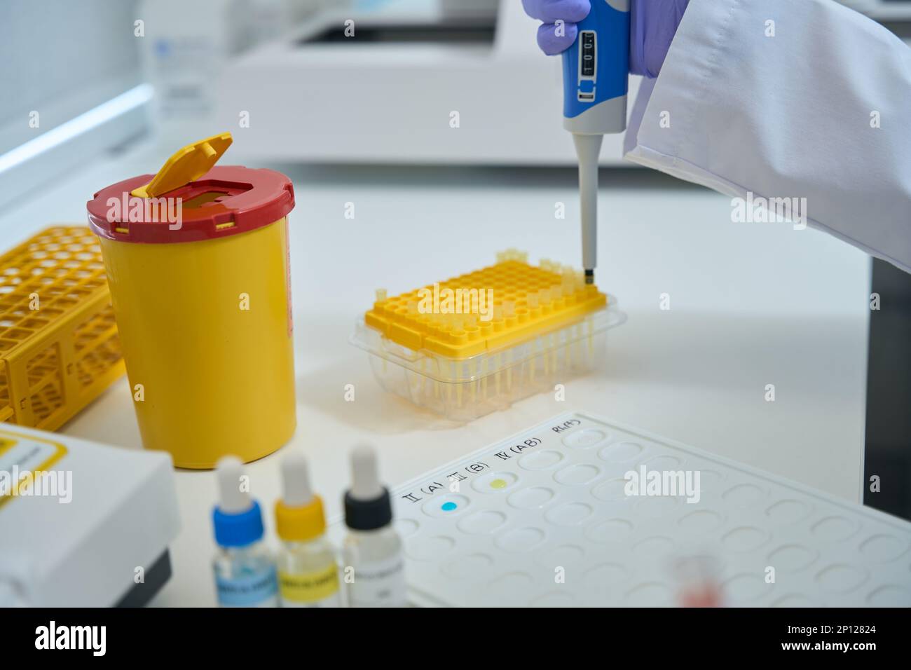 Laboratory Assistant In A Chemical Laboratory Conducts Blood Type Test 