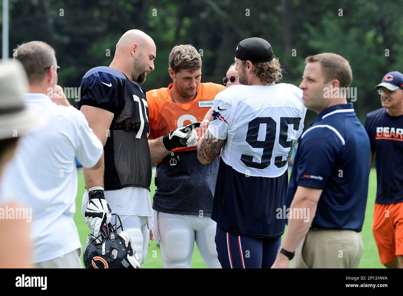 Tuesday August 16, 2016: Chicago Bears offensive tackle Kyle Long (75) and  quarterback Jay Cutler (6) play with Waylon Long while talking to Waylon's  father New England Patriots defensive end Chris Long (, image size:1300x956