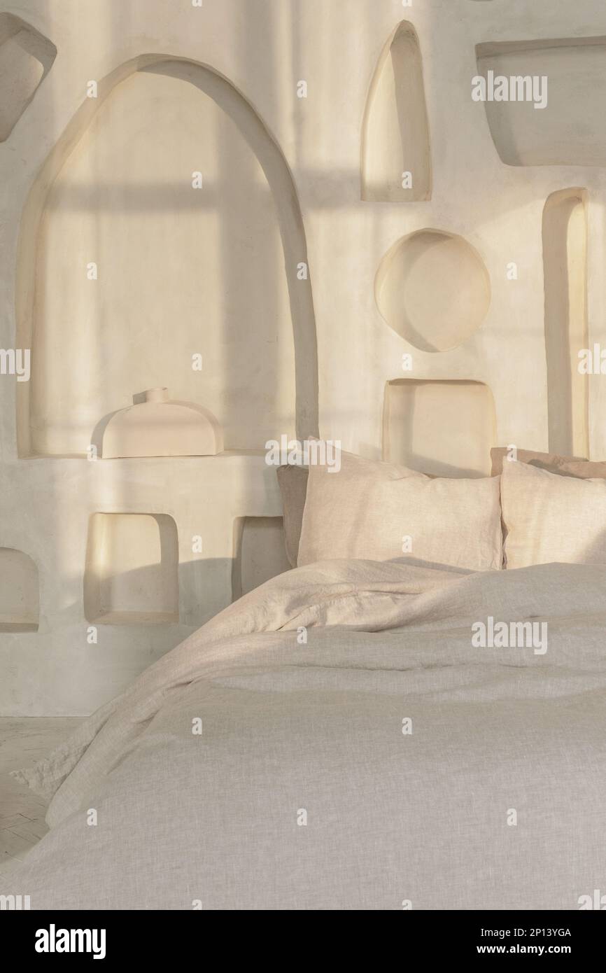 Cozy bedroom interior with trendy organic natural linen bedclothes. Eco