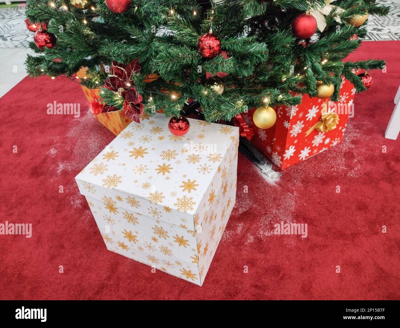 Christmas tree and gift boxes next to it Stock Photo