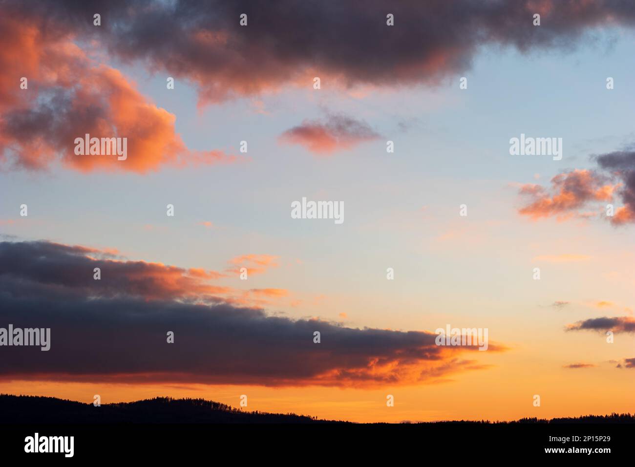 Dramatic blue sky during sunset blue pink and dark violet clouds. Stock Photo