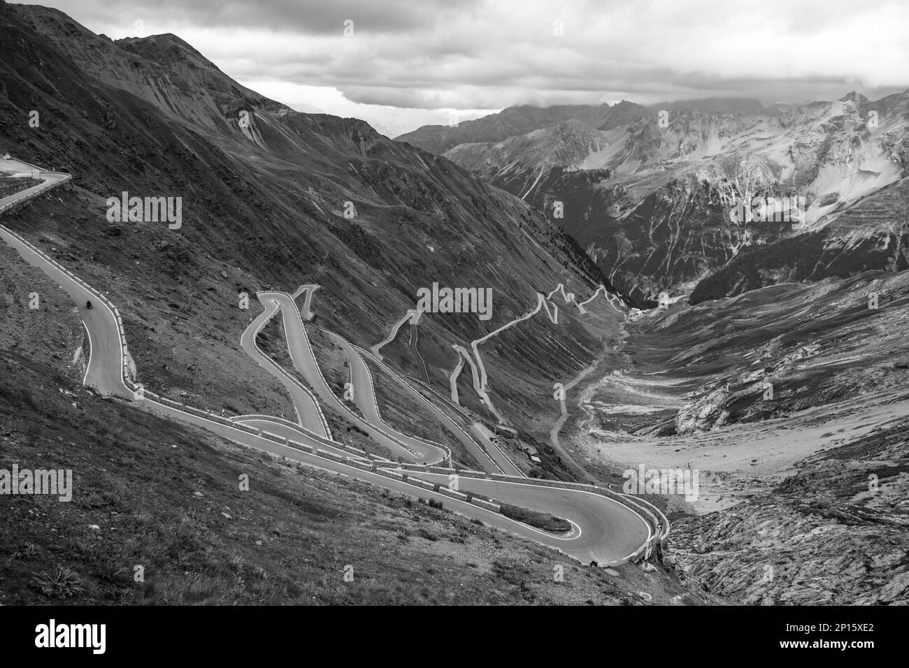Serpentines of alpine mountain road to Stelvio Pass, Italian: Passo dello Stelvio, South Tyrol, Italian Alps, Italy. Black and white image. Stock Photo