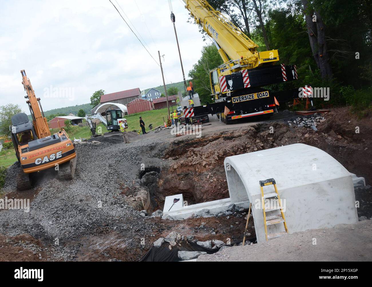 Workers from Terre Hill Concrete Products of Terre Hill, Pa., install the first of three