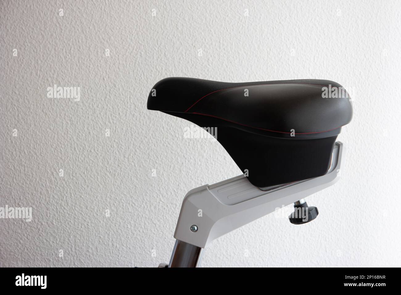 Indoor exercise bike saddle close up shot isolated on white Stock Photo