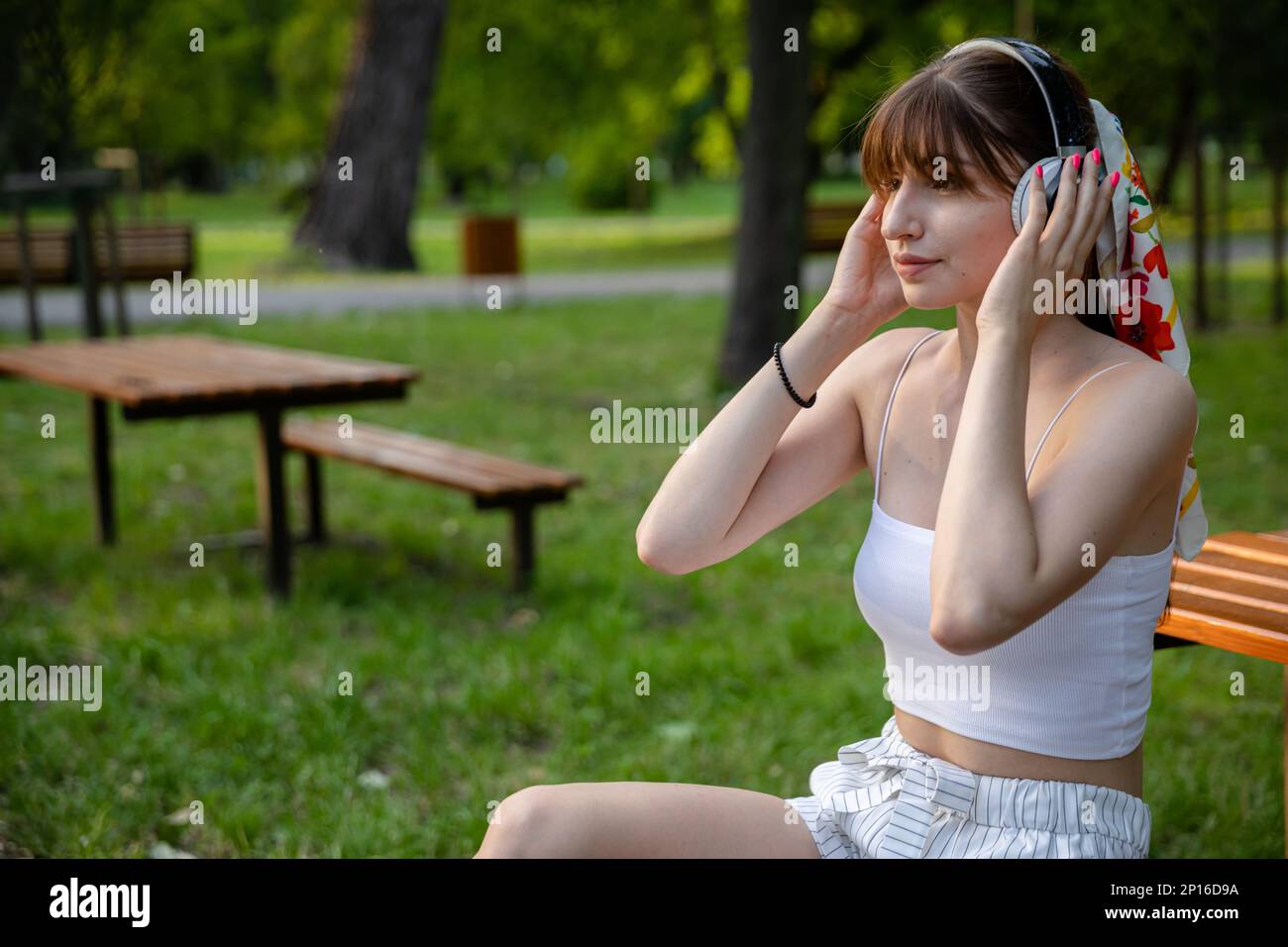 Pretty girl sits on grass hi-res stock photography and images - Alamy