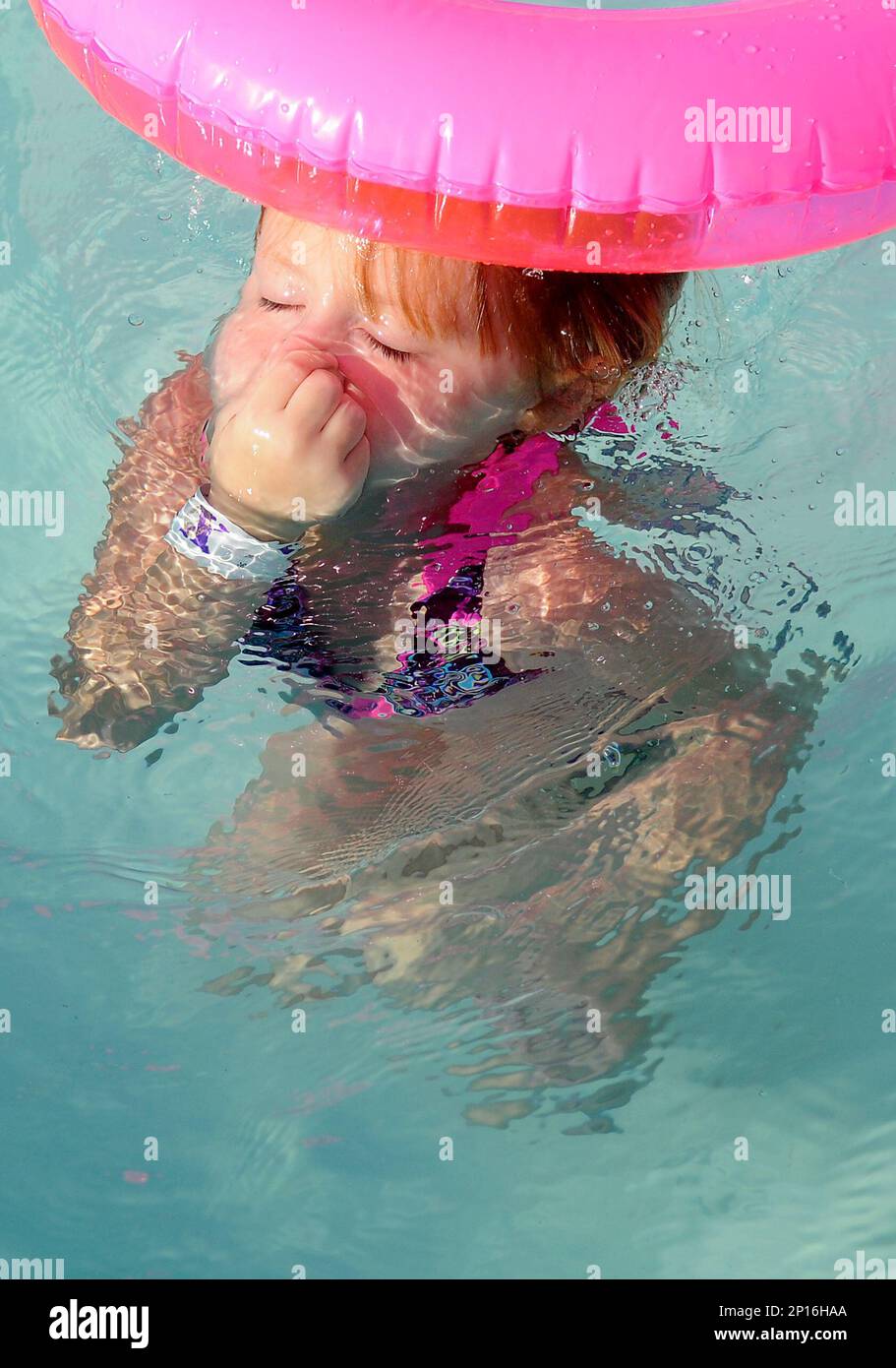 Reyanne Howard holds her nose as she plays at Splash Zone Waterpark in