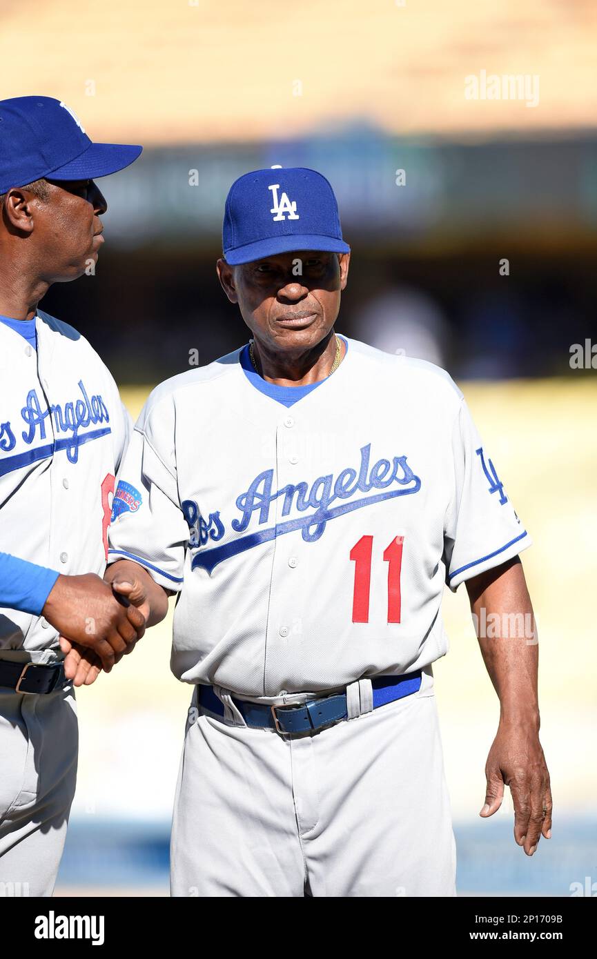 Former Los Angeles Dodger Manny Mota, left, gets a hug from his son Jose as  he is inducted into the Legends of Dodger Baseball prior a baseball game  between the Dodgers and