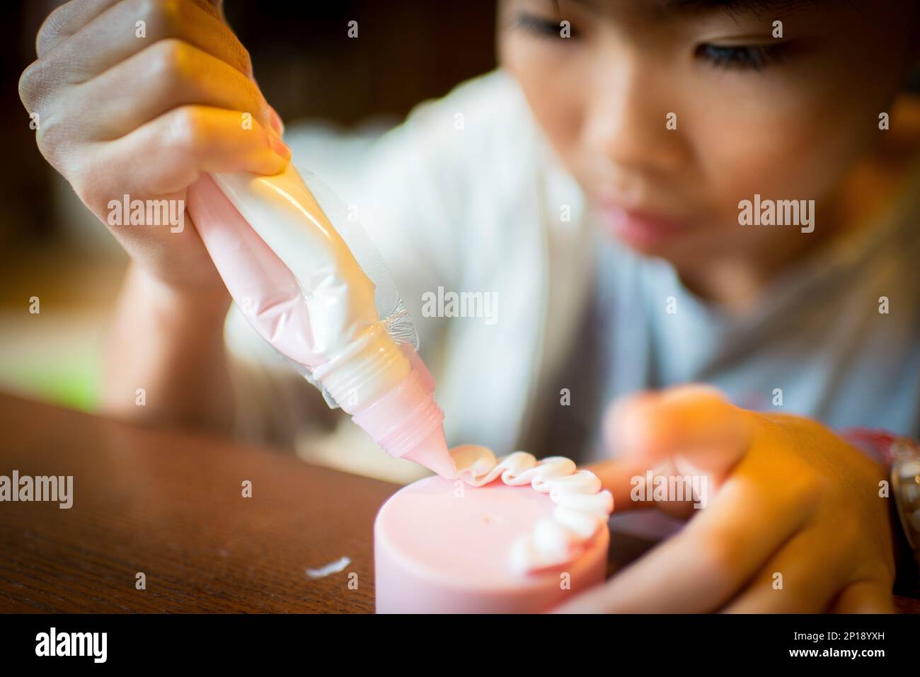Girls making craft cakes using silicone paste Stock Photo