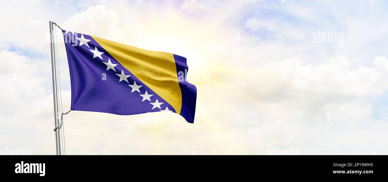Bosnia and Herzegovina flag waving on sky background. 3D Rendering ...