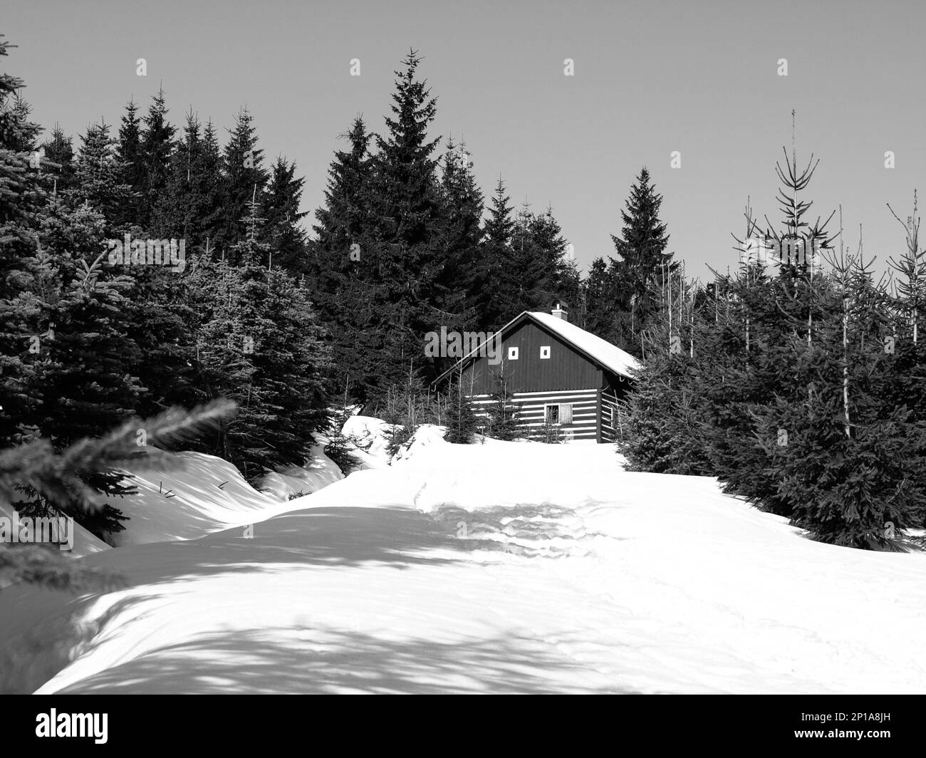 Small mountain hut in winter time, Jizera Mountains, Czech Republic, black and white image Stock Photo