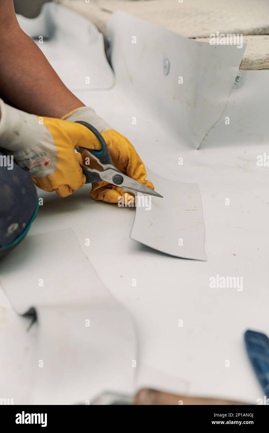 Worker specialized in mounting PVC membranes, TPO in the process of installing a water resistant Stock Photo