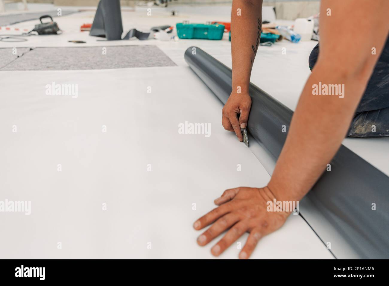 Worker specialized in mounting PVC membranes, TPO in the process of installing a water resistant Stock Photo