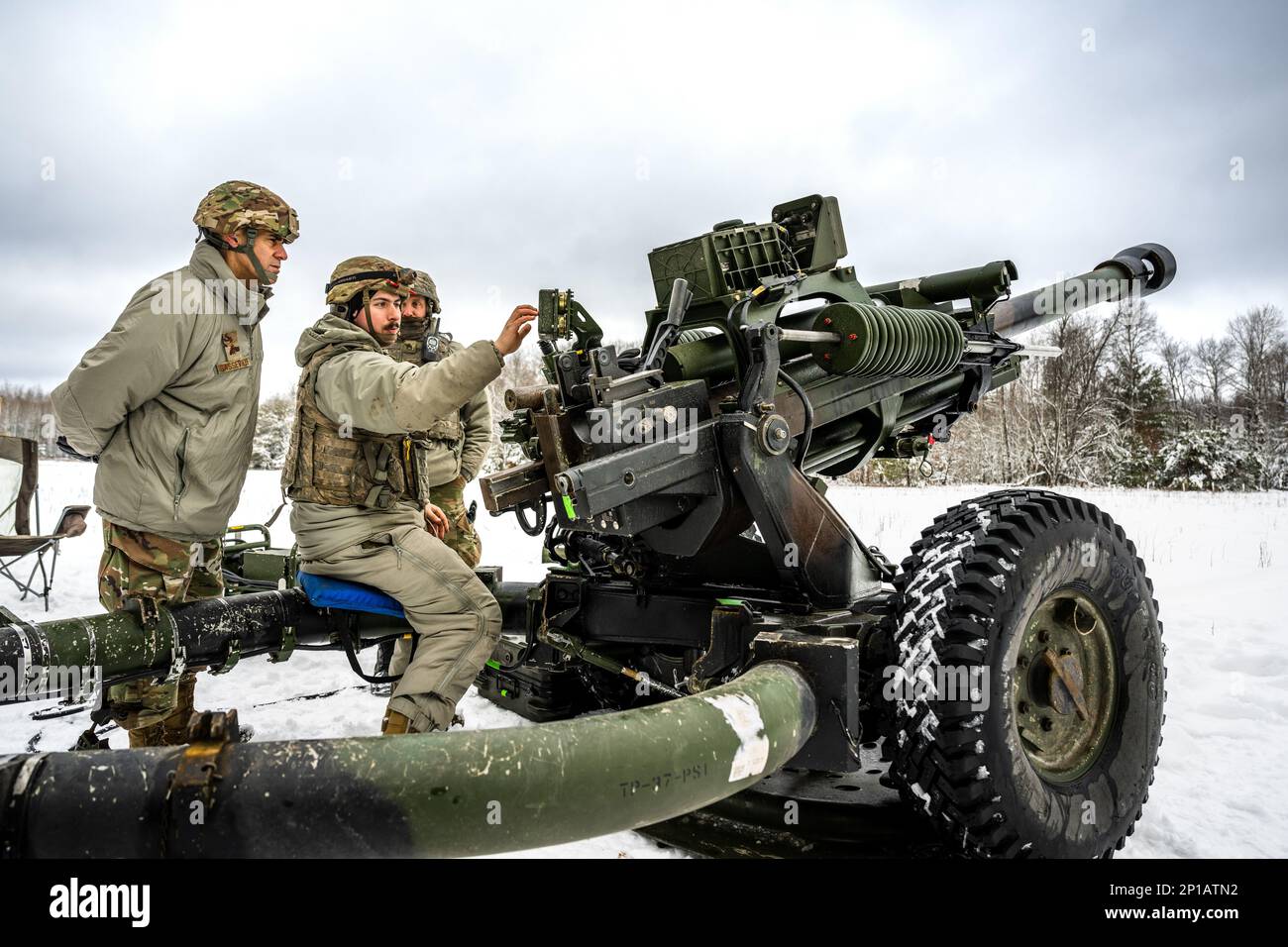 Army Cpl. Anthony Mischo, 1-120th Field Artillery Regiment, demonstrates to Air Force Lt. Gen. Marc Sasseville, Vice Chief of the National Guard Bureau, the capabilities of the M119 howitzer during Northern Strike 23-1, Jan. 23, 2023, at Camp Grayling, Mich. Units that participate in Northern Strike’s winter iteration build readiness by conducting joint, cold-weather training designed to meet objectives of the Department of Defense’s Arctic Strategy. Stock Photo