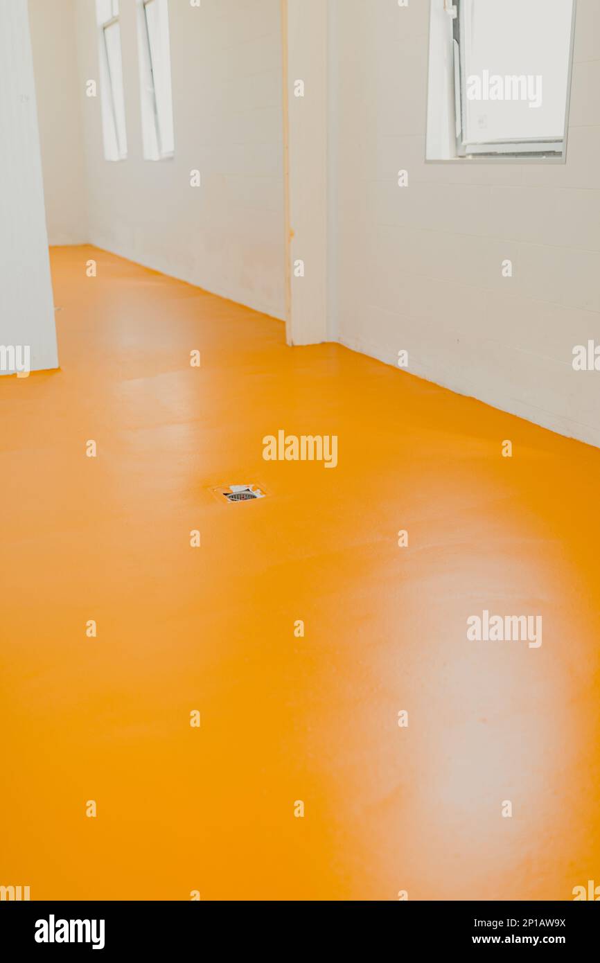 New polished concrete floor covered with a layer of yellow epoxy resin