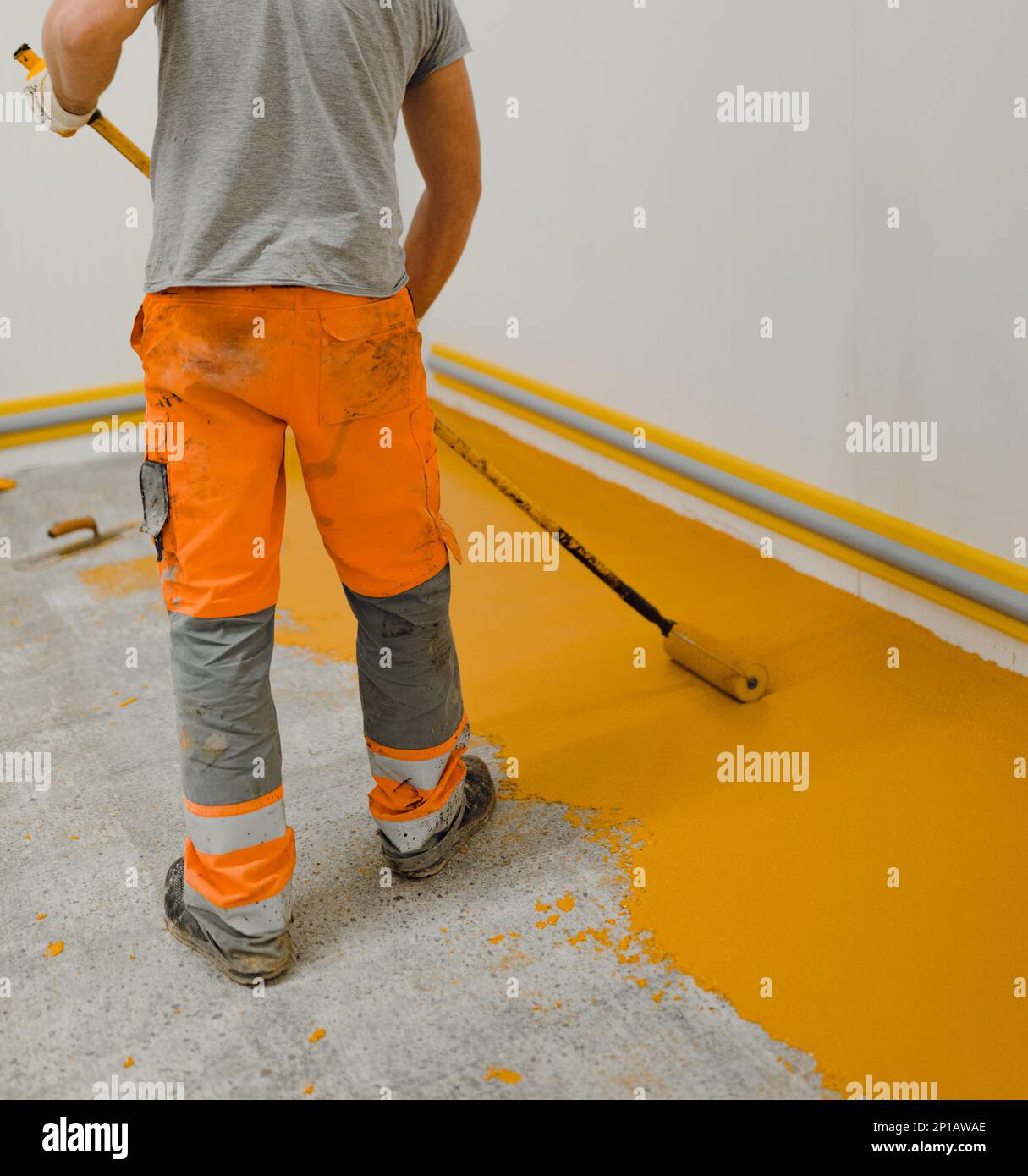 epoxy flooring applicator performs painting works with polyurethane