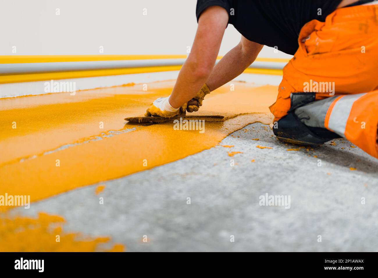 epoxy flooring applicator performs painting works with polyurethane