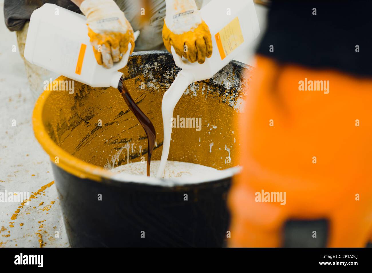 epoxy flooring applicator performs painting works with polyurethane