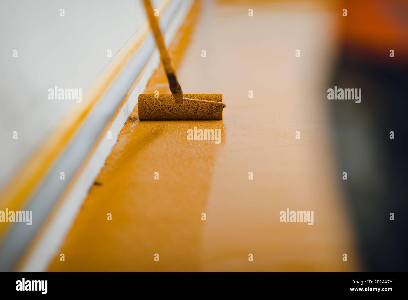 epoxy flooring applicator performs painting works with polyurethane