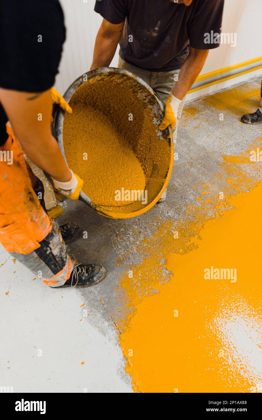 epoxy flooring applicator performs painting works with polyurethane