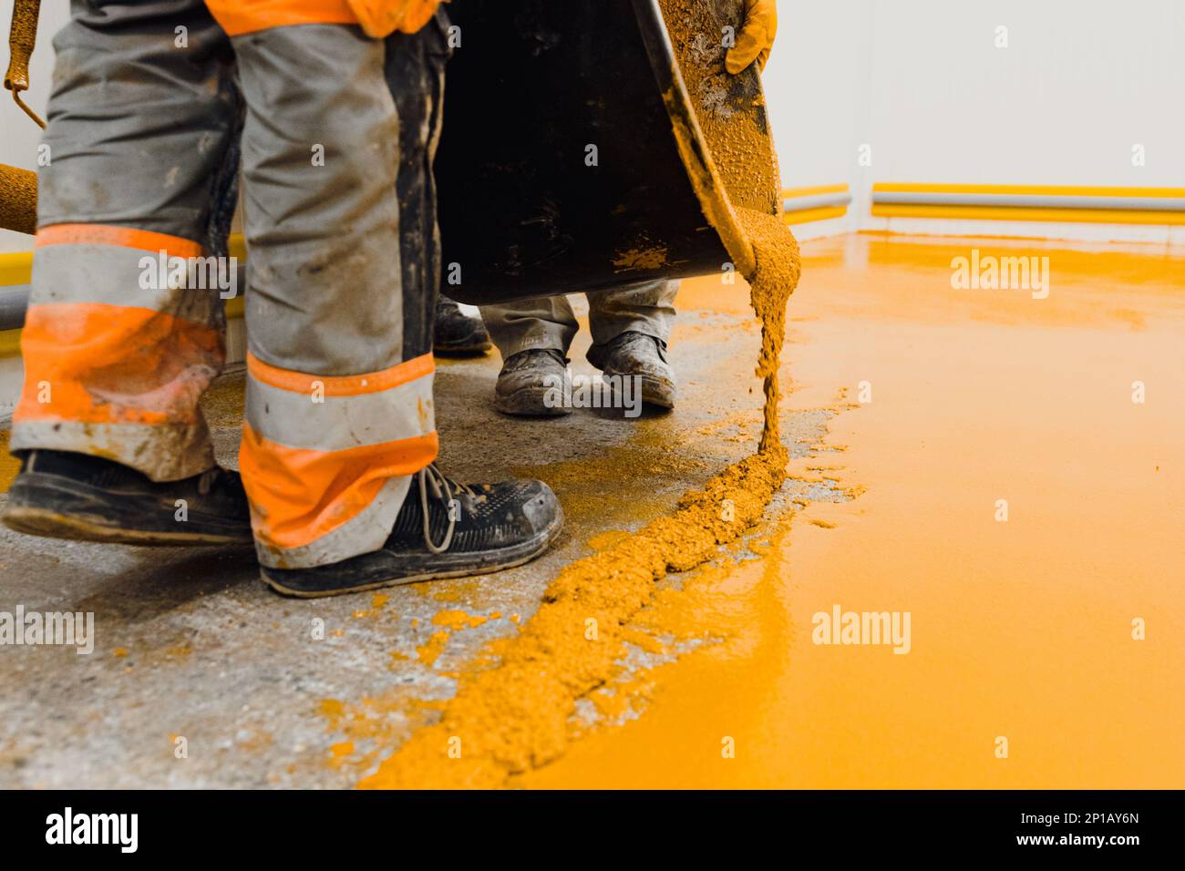 epoxy flooring applicator performs painting works with polyurethane