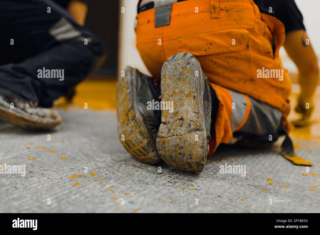 epoxy flooring applicator performs painting works with polyurethane