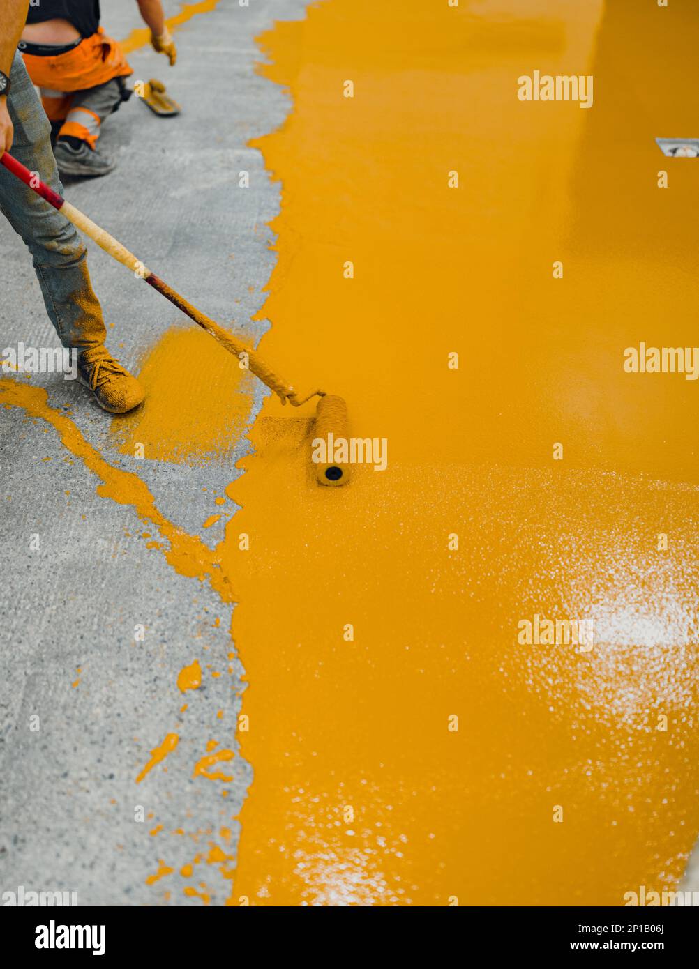 epoxy flooring applicator performs painting works with polyurethane