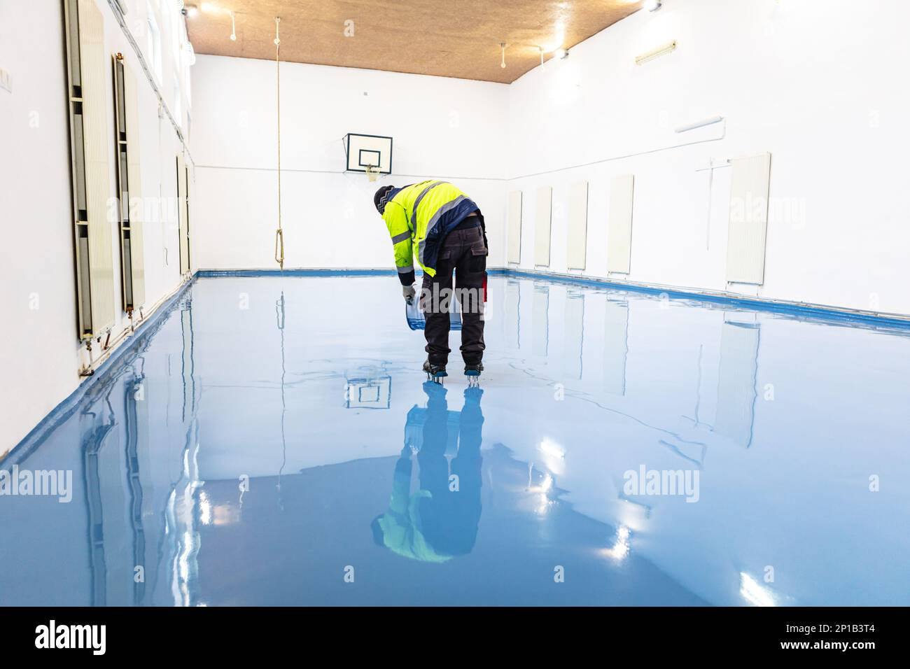 Self leveling blue epoxy floor in the gym Stock Photo Alamy