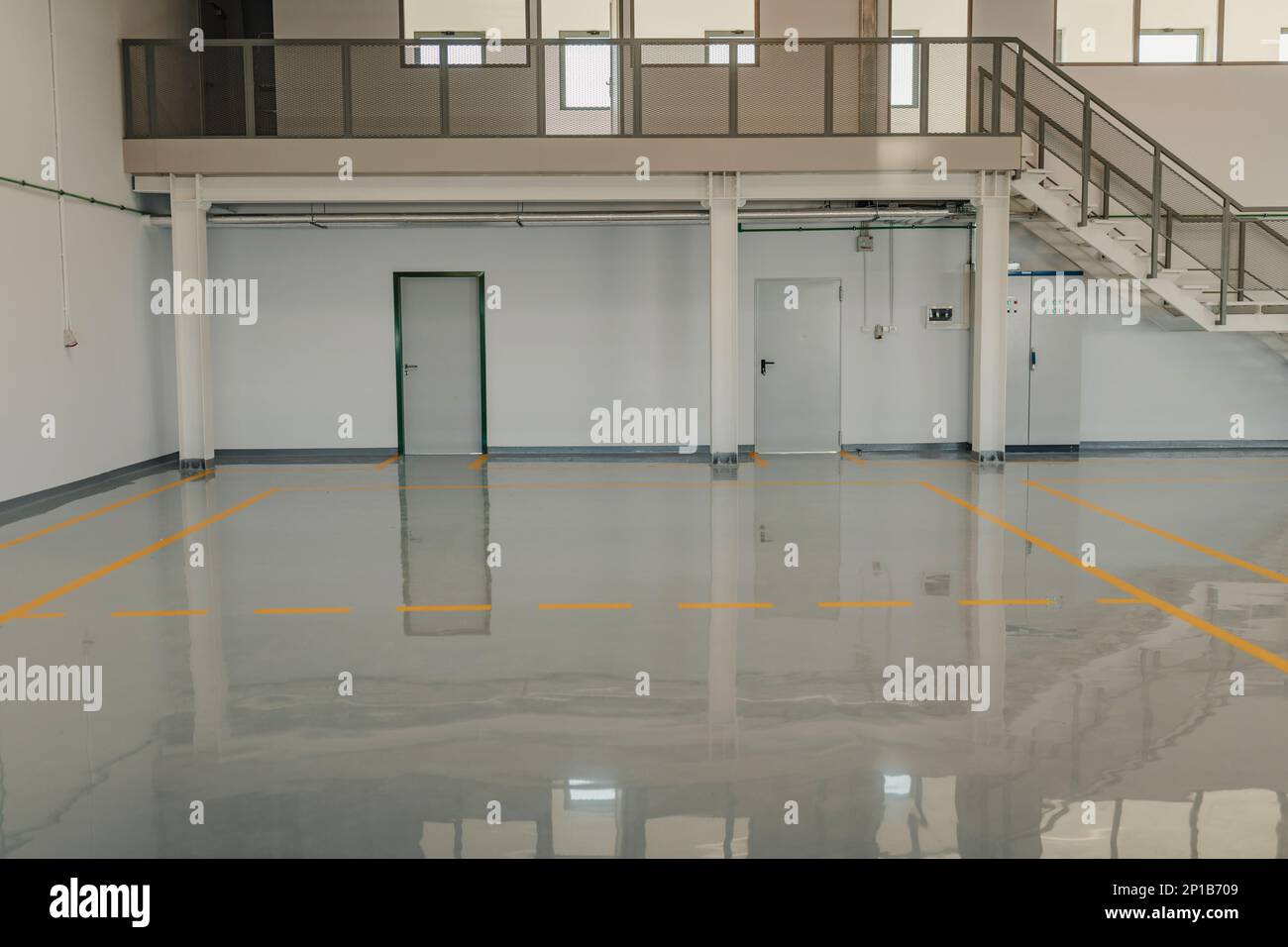 New  resin floor coating and marking signs in a car workshop. Stock Photo