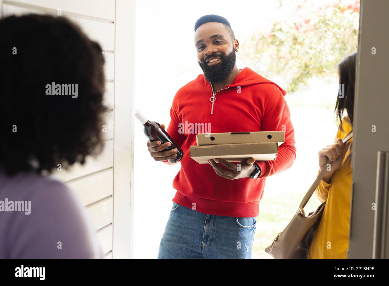 Greeting friends at the door hi-res stock photography and images - Alamy