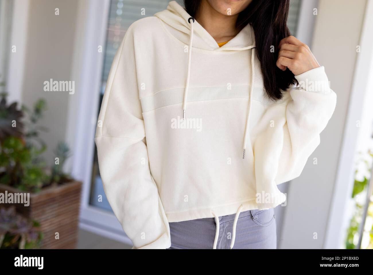 Midsection of biracial woman wearing white sweatshirt with copy space Stock Photo