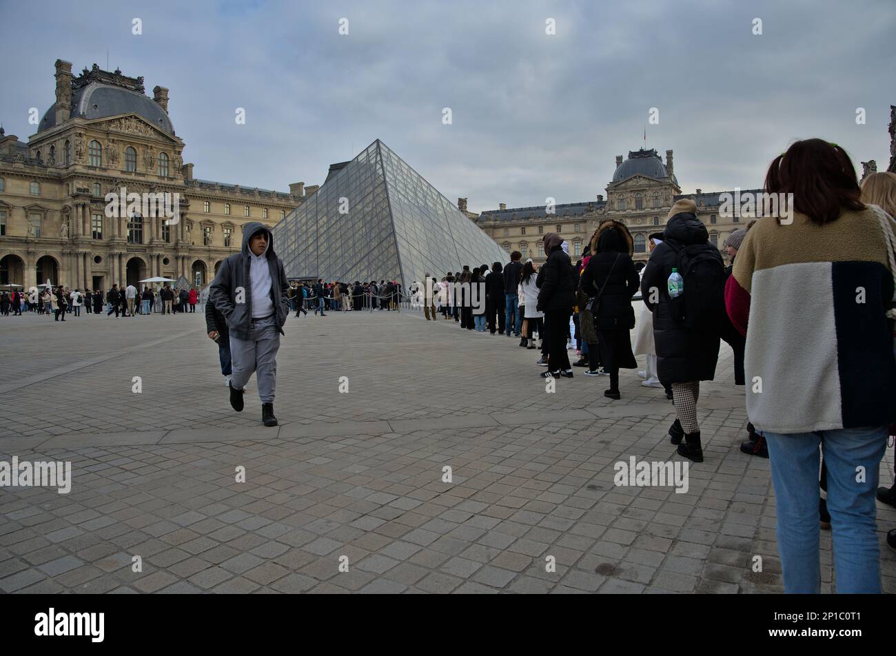 Queue at the Louvre to enter through the pyramid in the winter. Paris, France Stock Photo